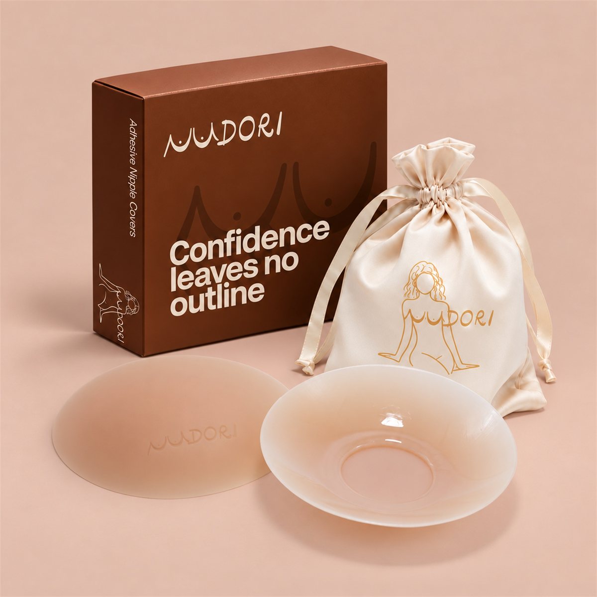 Nudori Adhesive Nipple Covers in Skin with the Nudori box and satin pouch on a nude studio background.