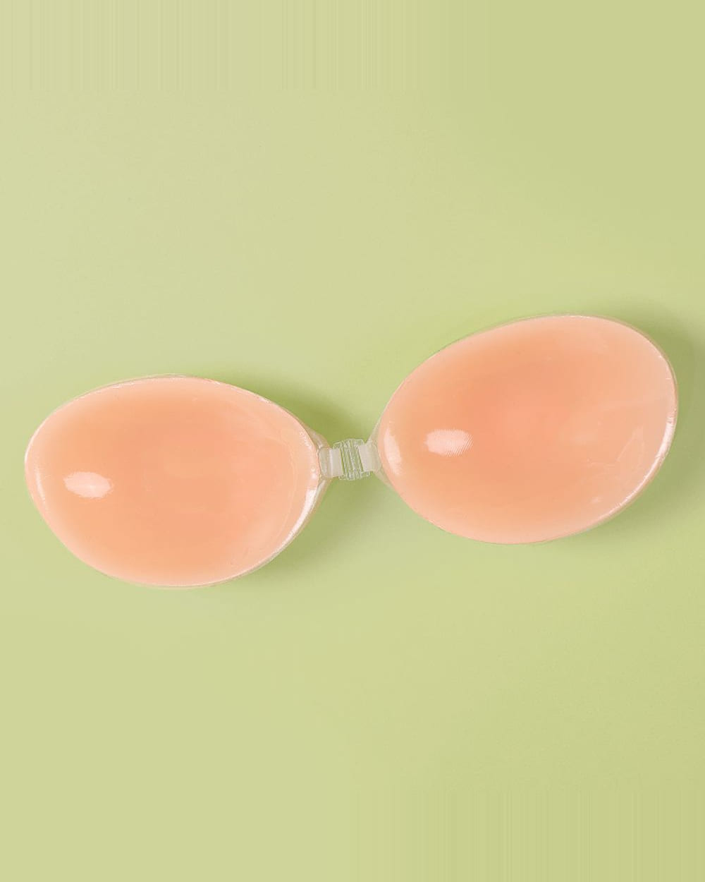 The Nudori Moon Silicone Bra opened flat, its two moon-shaped cups joined by the clear MagLock clasp.